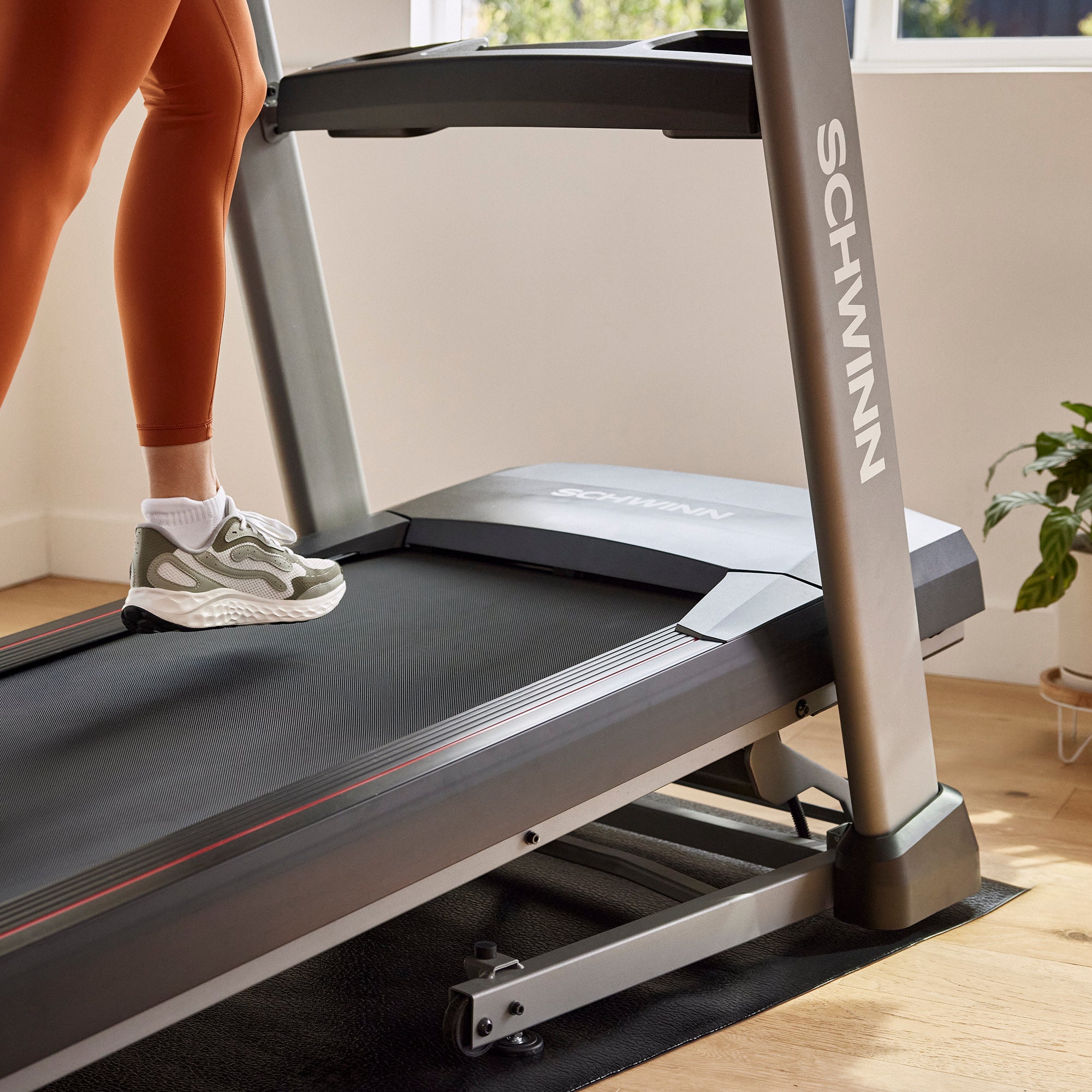 Person using a Schwinn treadmill in a home setting