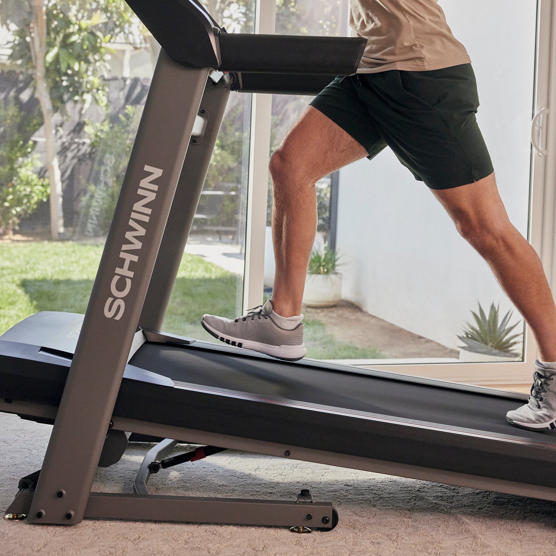 Person using a Schwinn treadmill in a home setting