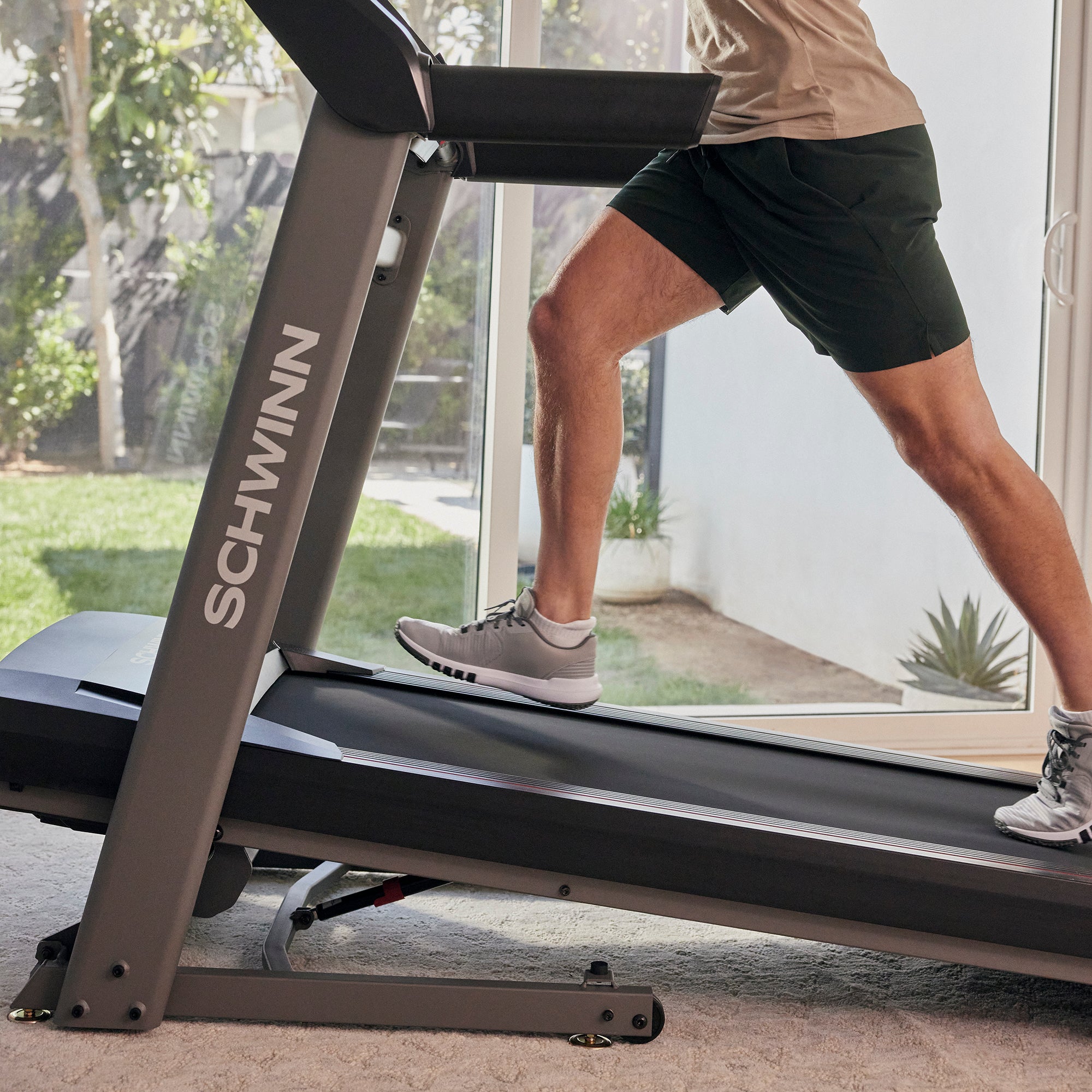 Person using a Schwinn treadmill in a home setting
